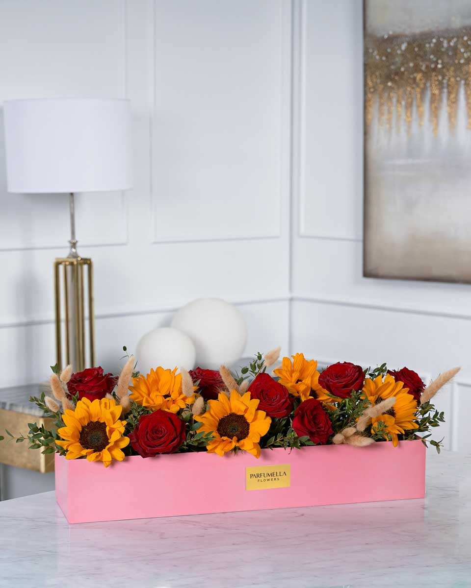 Color Loco pink roses, lilies and dried palm on pink box
